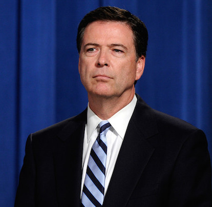 FBI Director James Comey listens during a news conference announcing a deal between the U.S. government and French bank BNP Paribas at the Justice Department in Washington, Monday, June 30, 2014. The U.S. government and French bank BNP Paribas have agreed to a settlement over alleged sanctions violations that would require the bank to plead guilty, pay almost $9 billion in penalties and face other sanctions. (AP Photo/Susan Walsh)