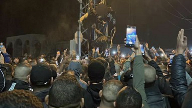 Watch as hundreds of Muslims in Gaza cheer and whistle as 2 Muslim men are hung upside down on a metal pole. thumbnail