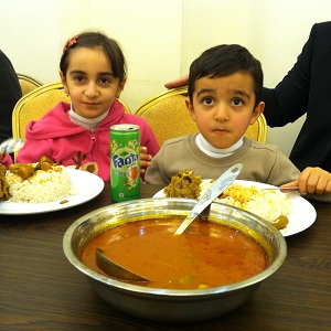 Refugee kids enjoy their Christmas dinner