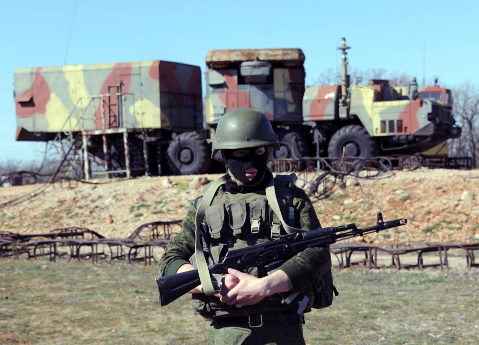 A member of the Russian forces guards in front of surface-to-air S300 missiles in a Ukrainian anti-aircraft missile unit on the Cape of Fiolent in Sevastopol on March 5, 2014. A military source has told Interfax-Ukraine that Russian commandos have seized control of the anti-aircraft missile systems and are guarding them. AFP PHOTO/ VIKTOR DRACHEV