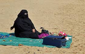 burka clad woman beach