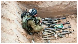 idf soldier with captured weapons in gaza