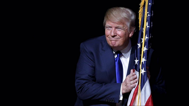 trump embraces american flag